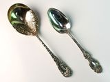 two spoons and a spoon on a white surface
