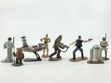 star wars action figures are lined up on a white surface