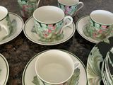 a lot of cups and saucers on the table