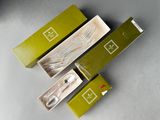 three boxes of toothbrushes sitting on top of a table