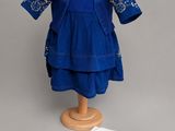 an image of a blue dress and a white shirt on a mannequin