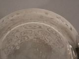 a glass bowl with a spoon in it on a table