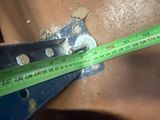 a measuring tape that is being used to measure the height of a piece of metal