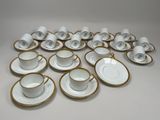 many cups and saucers sitting on the table