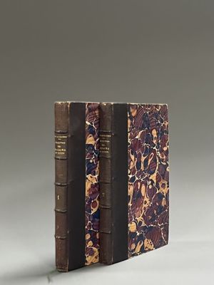 two books sitting on top of each other on a table