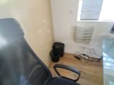 a black office chair sitting in front of a computer monitor