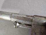 a close up of a metal object on a white surface