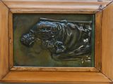 une photo d'une plaque en bronze dans un cadre en bois