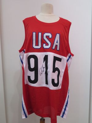 the shirt is red and white with the number 955 on it