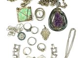 a lot of jewelry that is laying out on the table