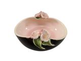 a black and white bowl with pink flowers on it