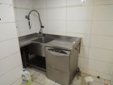 a kitchen with a sink and a dishwasher in it