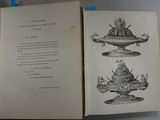 an open book with a drawing of a statue on it