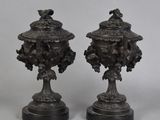 pair of antique bronze urns with birds and flowers on them
