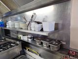 many dishes on the shelves in the kitchen