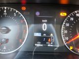 a close up of a car dashboard with various gauges and numbers