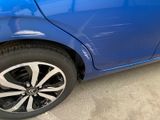 a close up of a blue car with black rims
