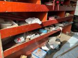 a red shelving with lots of tools on it