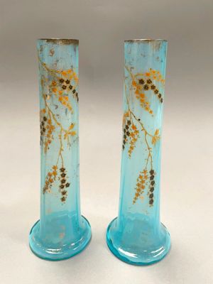 pair of blue glass vases with yellow flowers on them