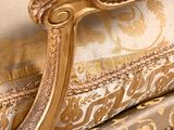 a gold couch with a gold and white pattern on it