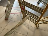a luggage cart sitting on the floor next to a luggage cart
