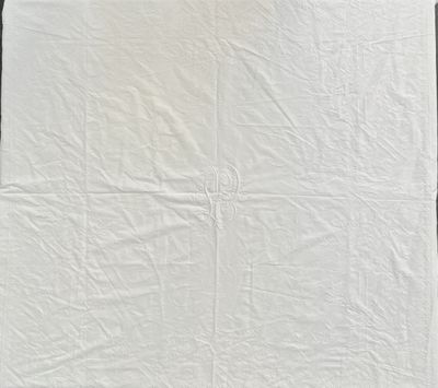 a white towel on a wooden table next to a window
