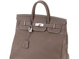 a brown leather handbag on a white background