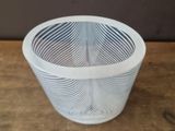 a white basket that is sitting on a wooden table