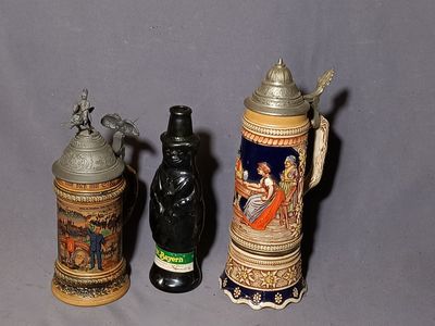 three beer mugs sitting next to each other on a table