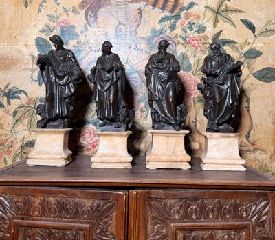 trois statues posées sur un meuble en bois dans une pièce
