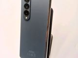 a close up of the back of a black phone with a camera on top of it