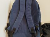 a blue backpack and a pair of shoes on the floor