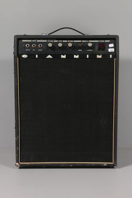 a black and gold amplifier sitting on top of a table