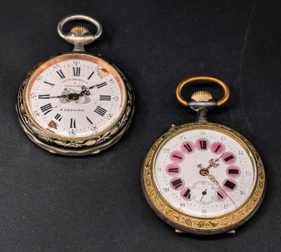 two clocks that are sitting next to each other on a table