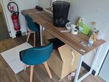 a desk and chair in a room with wood flooring
