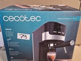 the box is open to show the contents of a coffee machine