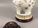 a white vase and a small wooden box on a table