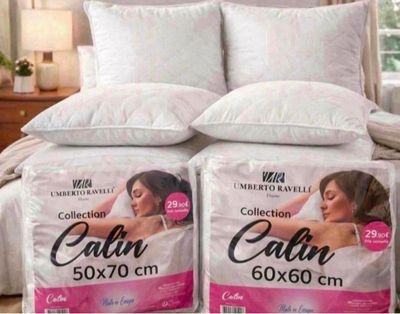 two pillows on a bed with a picture of a woman on it