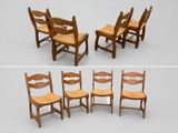 several wooden chairs are lined up in a row on a white surface