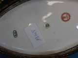 a close up of a gold and white plate with a label on it