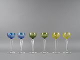 six different colored wine glasses lined up in a row