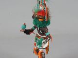 figurine of a native american man with a green and orange headdress
