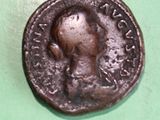 an old coin with a man on it on a green surface