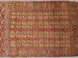 a red and yellow rug with a pattern on it