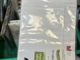 a green bin full of books and papers on a table
