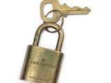 a brass padlock with a key attached to it