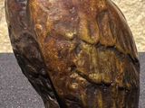 a statue of an owl that is sitting on a table