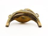 gold plated metal object with a leaf design on the top of it