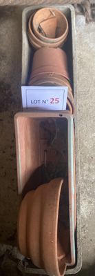 a box with a bunch of clay pots inside of it