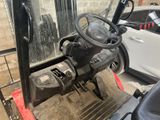 a forklift with a steering and steering wheel in a parking lot